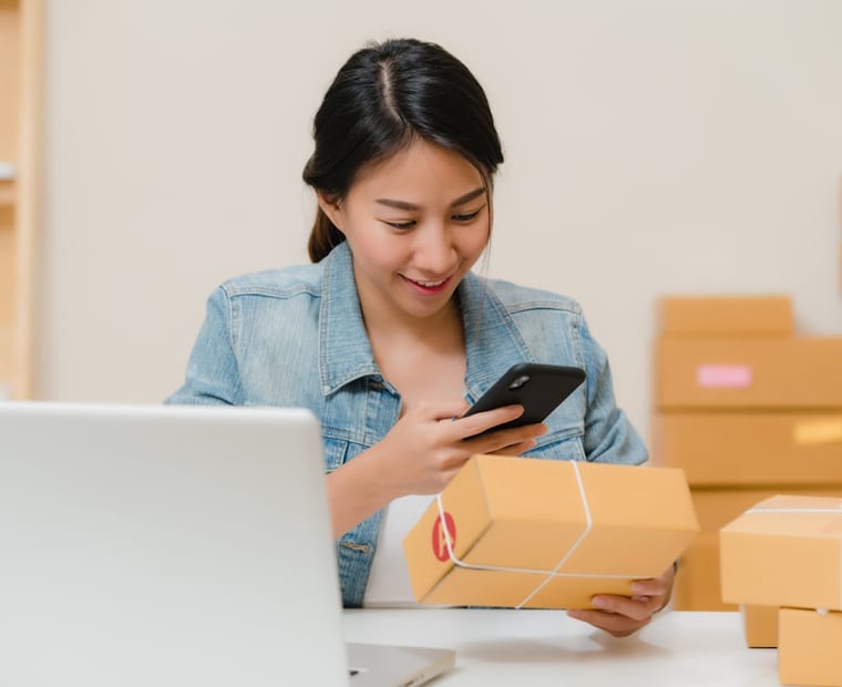 A creator preparing a parcel to ship to a backer